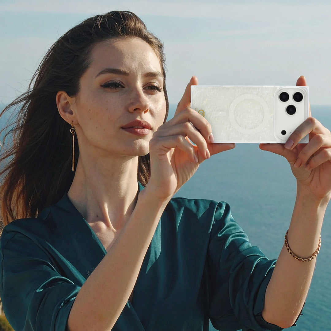 A person holding an opalescent rectangle iPhone case with a soft pastel color shift