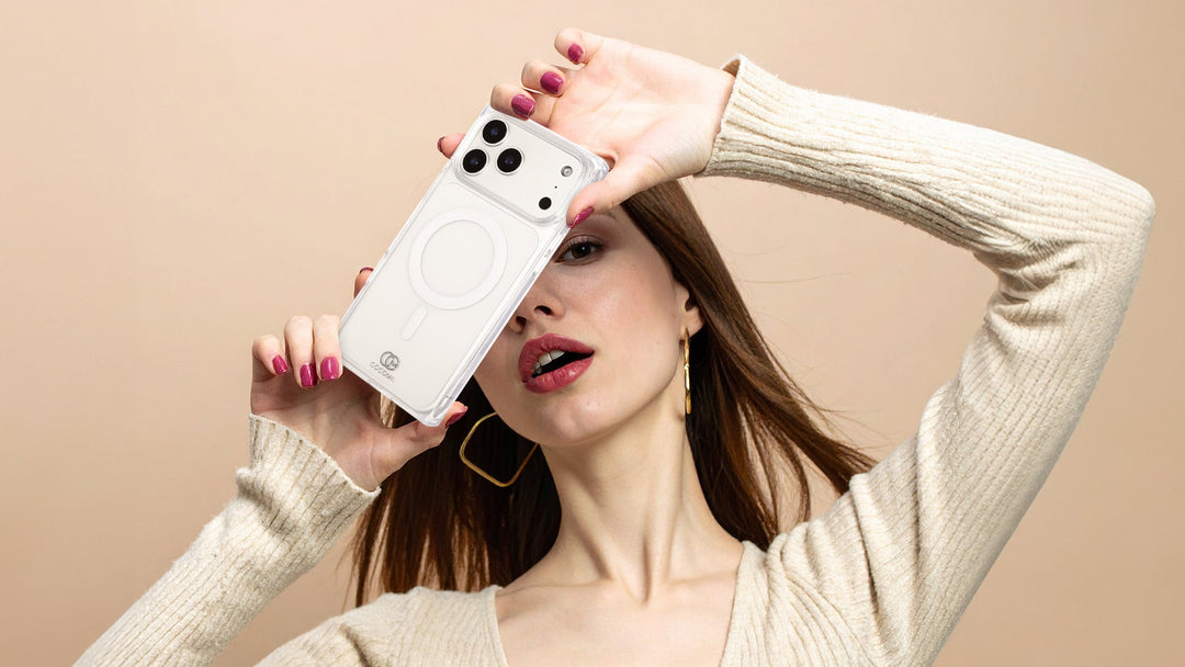 A woman holding a clear rectangle iPhone case with the MagSafe ring visible through it