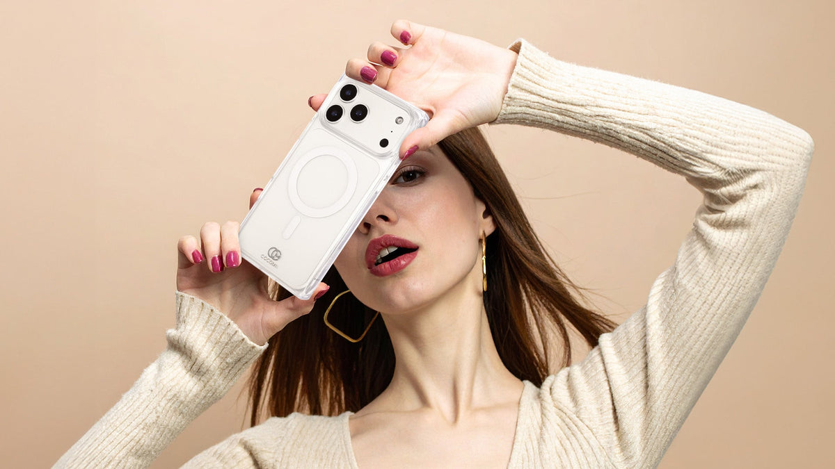 A woman holding a clear rectangle iPhone case with the MagSafe ring visible through it