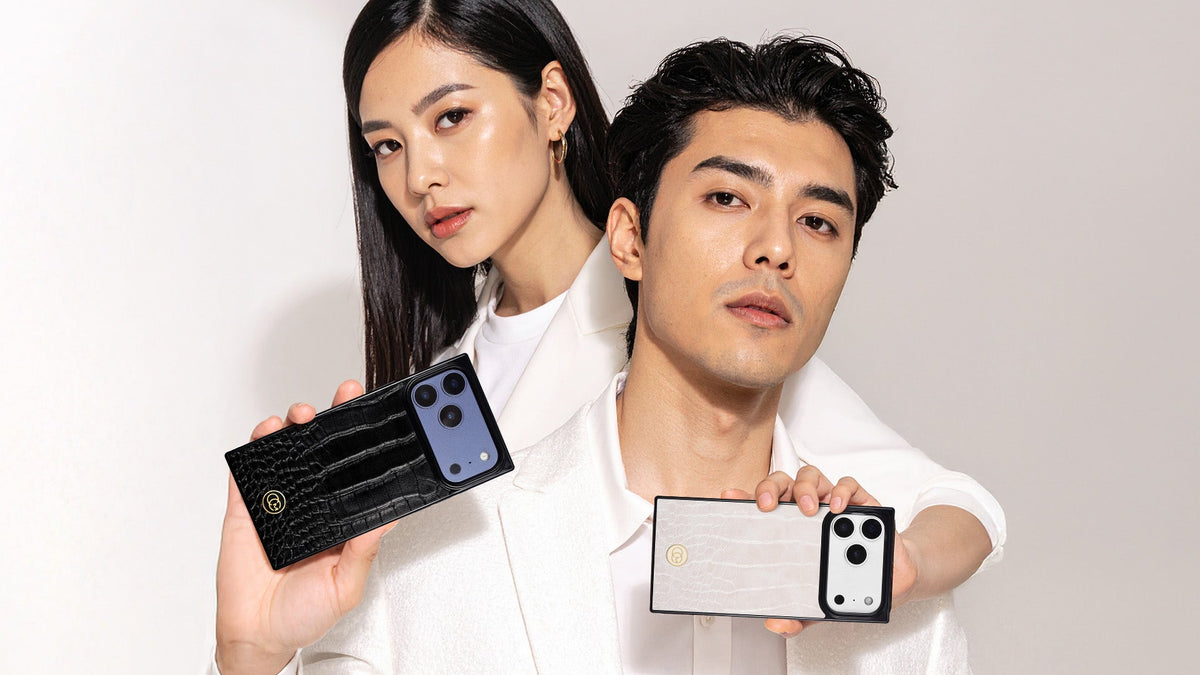 Woman holding a black crocodile texture phone case in front of a man in white