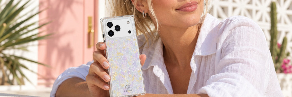 Smiling woman in Palm Springs holding a COCOMII opal finish rectangle case in Aurora beside her face