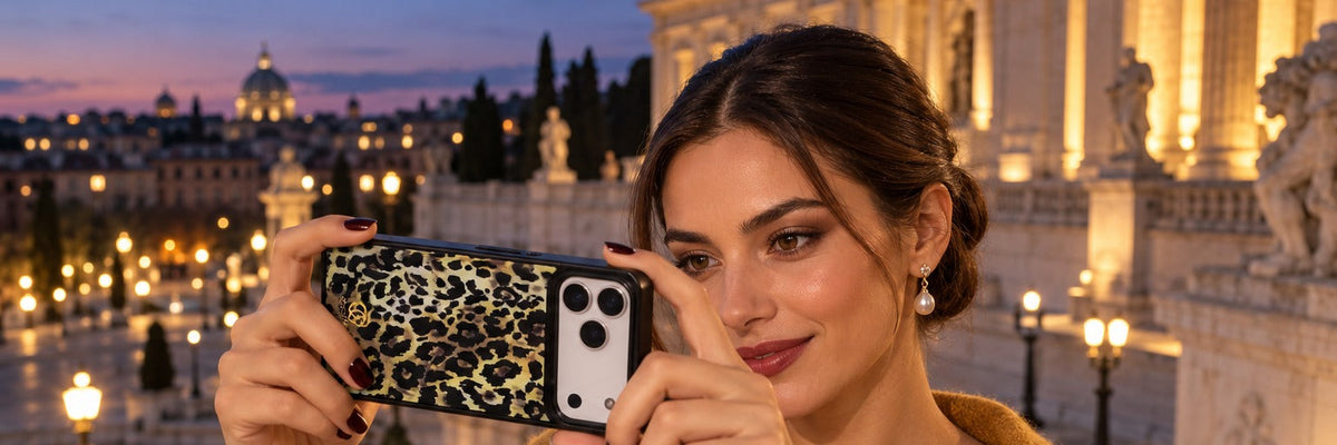 Woman in a marigold satin dress on museum steps at dusk photographing the facade with a COCOMII leopard print case in Ivory