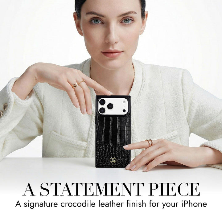 COCOMII croc-embossed MagSafe iPhone case in Black - held up on a table as a statement piece